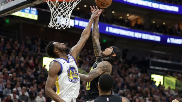 Feb 12, 2024; Salt Lake City, Utah, USA; Utah Jazz guard Jordan Clarkson (00) is fouled by Golden State Warriors forward Andrew Wiggins (22) during the second quarter at Delta Center.
